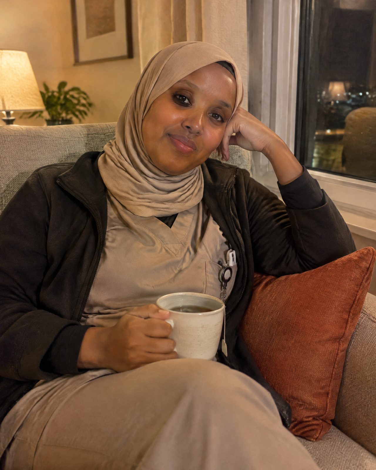 A Somali-Canadian care worker relaxing with tea after a shift